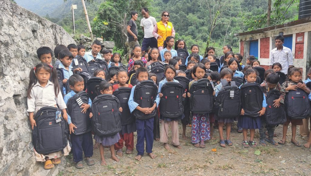 distributing school bags to students from edventure nepal charity